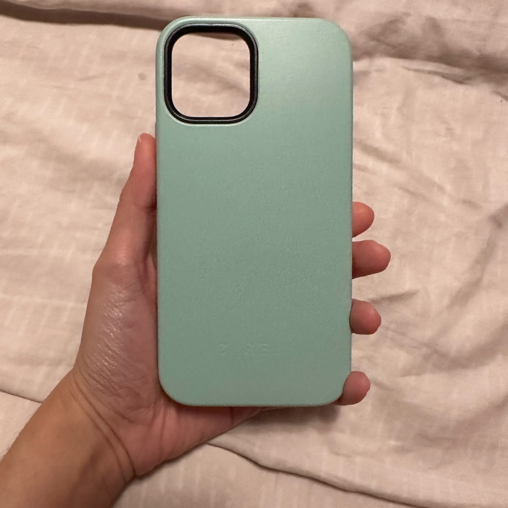 Casely Bold iPhone 12 Pro case in mint green on pink.
